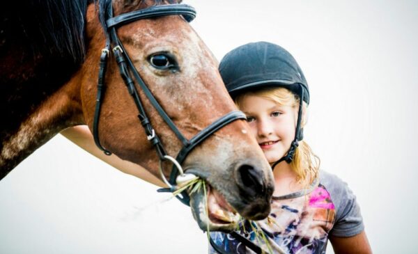 A young girl and a horse at Harties Horse and Trail Unlimited in Hartbeespoort.