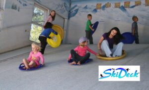 Kids enjoying bum boarding at The Ski Deck in Ferndale with a parent