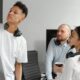 Three people huddled around a whiteboard