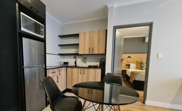 The kitchen area in a Deluxe Suite at The Mint Hotel 84 on Katherine in Sandton