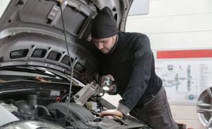 A stock photo of a man working on a car