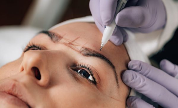 A stock photo of a woman having microblading done