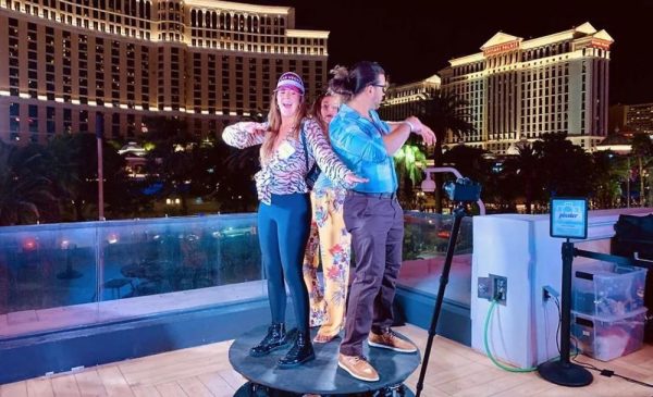 A group of people trying a 360 spin photo booth