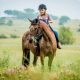 A young girl enjoying a 1-hour horse riding experience from Harties 'Horse and Trail' Unlimited in Hartbeespoort
