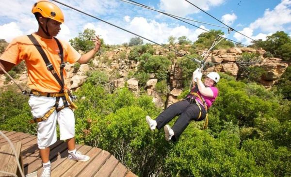 A woman and an instructor trying a canopy tour at Magaliesberg Canopy Tours in Rustenburg