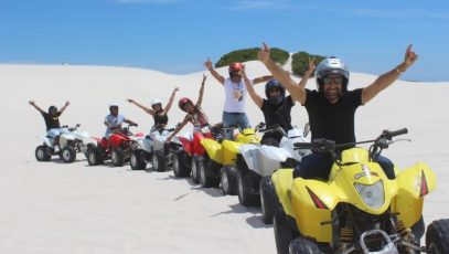 A goup of people enjoying a quad-biking experience from Quadzilla Adventures at Atlantis Dunes