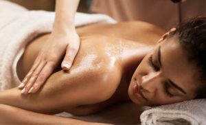 A stock photo of a woman receiving a full-body massage
