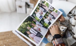 A person flipping through a custom hardcover photo book from Elegant Pix available for national delivery