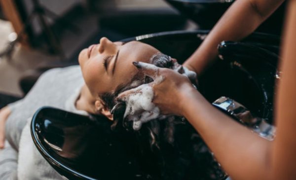 A stock photo of a woman getting her hair washed at the hair salon