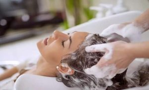 A stock photo of a woman having her washed at a hair salon