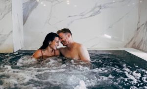 A stock photo of a couple in a jacuzzi at the spa