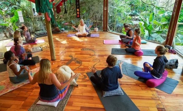 Guests practicing yoga at Mantis and Moon Backpackers in Umzumbe