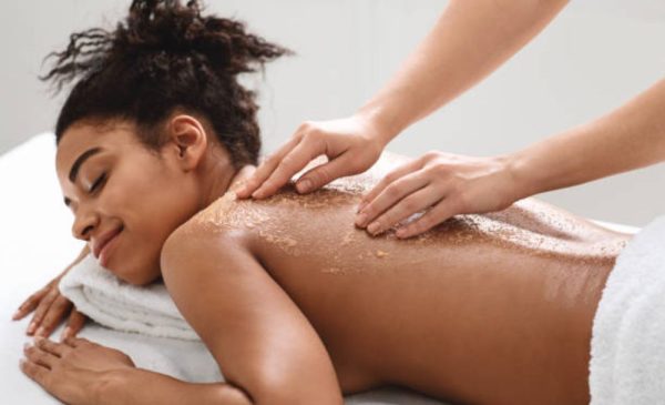 A stock photo of a woman getting a back exfoliation at the spa