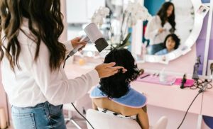 A stock photo of a woman having her hair done at a hair salon