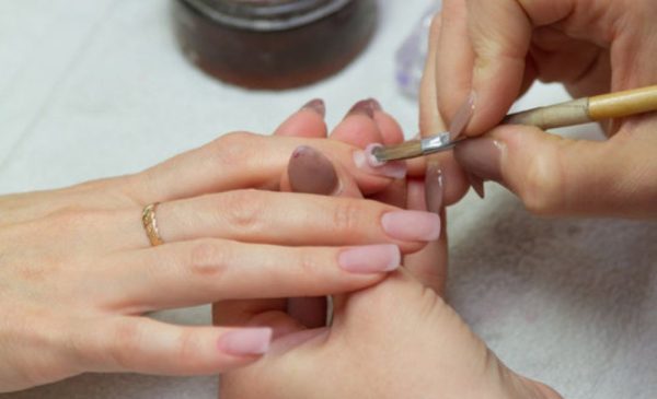 A stock photo of a woman getting her nails done at the salon