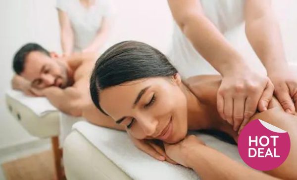 A stock photo of a couple enjoying a massage at the spa