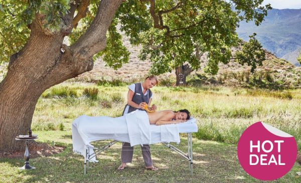 A woman getting a massage outdoors from Wellness in the Winelands at Lourensford Estate in Somerset West