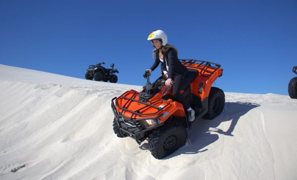 A woman during a quadbiking experience from Wild X Adventures at the Atlantis Dunes
