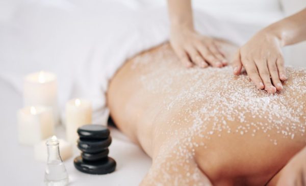 A stock photo of a woman getting a back scrub at the spa